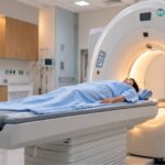 Patient undergoing a digital PET-CT scan in a modern diagnostic imaging centre for cancer detection, diagnosis, and treatment monitoring.